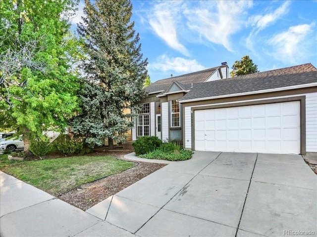 view of front of house featuring concrete driveway and a garage