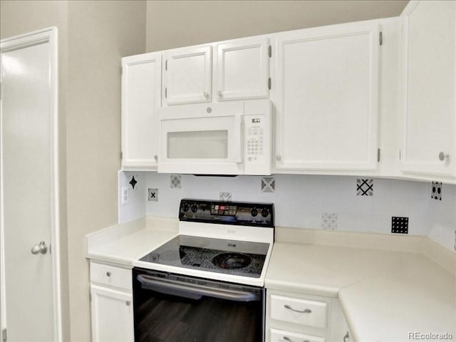 kitchen with range with electric stovetop, white microwave, backsplash, white cabinetry, and light countertops