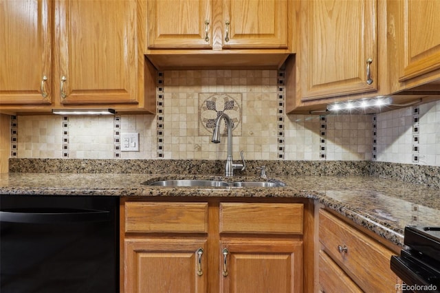 kitchen featuring stone counters, decorative backsplash, black electric range, and sink