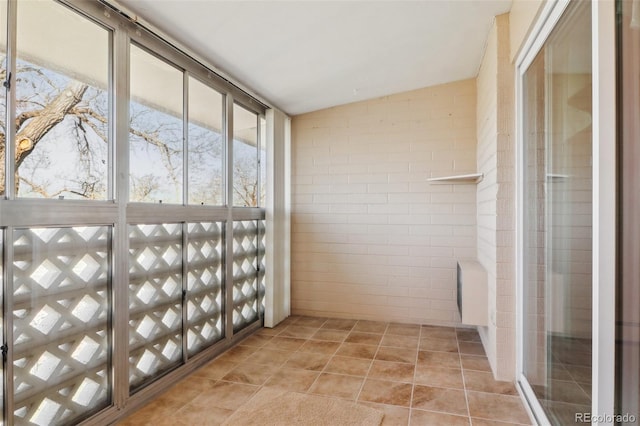 unfurnished sunroom featuring vaulted ceiling