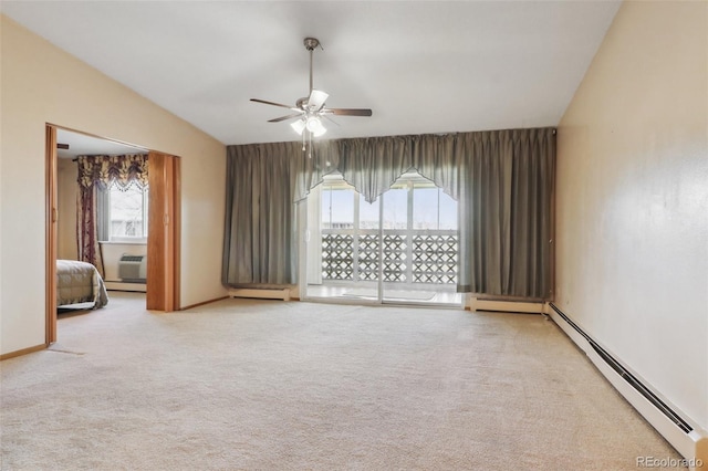 carpeted empty room with ceiling fan, a healthy amount of sunlight, and a baseboard radiator