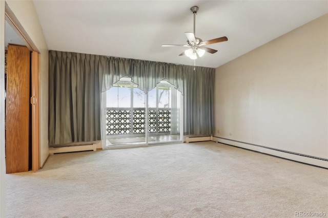 carpeted spare room featuring baseboard heating and ceiling fan