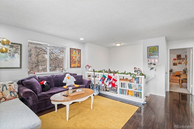 living room featuring a textured ceiling and hardwood / wood-style flooring