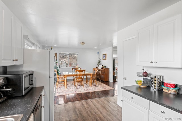 kitchen with white cabinets and light hardwood / wood-style floors