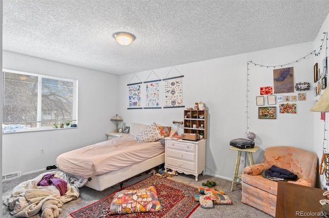 carpeted bedroom with a textured ceiling