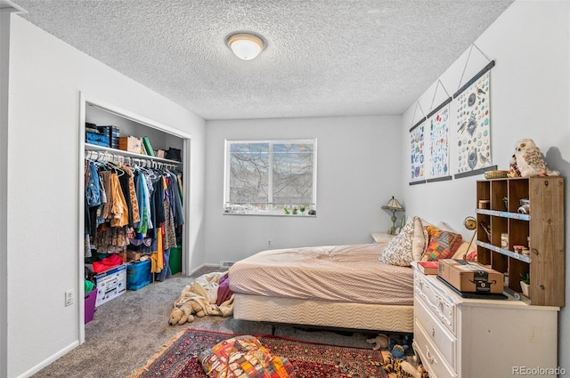 bedroom with a closet, carpet, and a textured ceiling