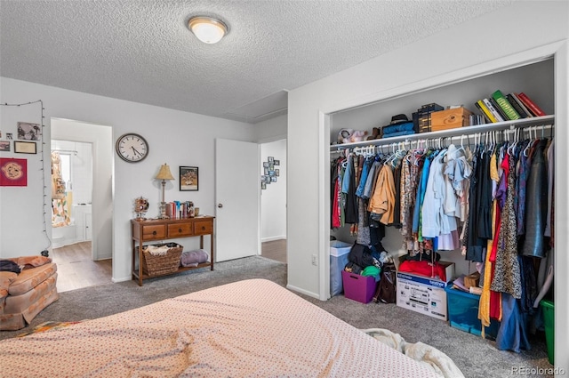 carpeted bedroom featuring a closet and a textured ceiling