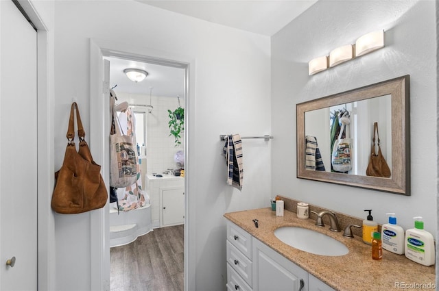 bathroom featuring hardwood / wood-style flooring, vanity, and decorative backsplash