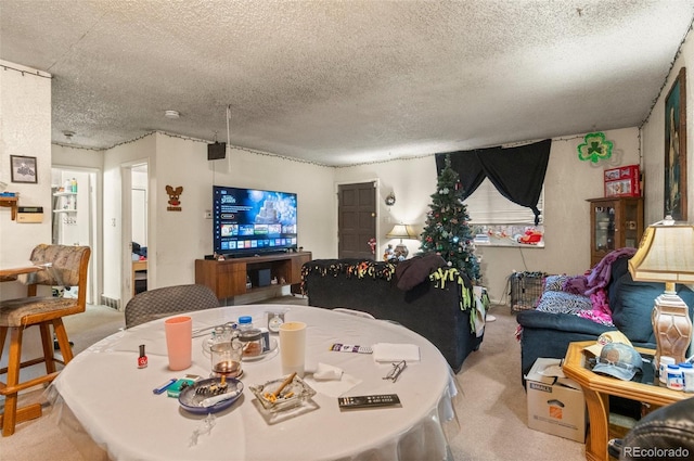 carpeted dining space featuring a textured ceiling