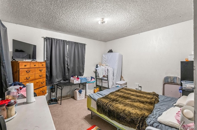 bedroom featuring carpet and a textured ceiling