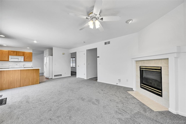 unfurnished living room featuring carpet floors, recessed lighting, and visible vents