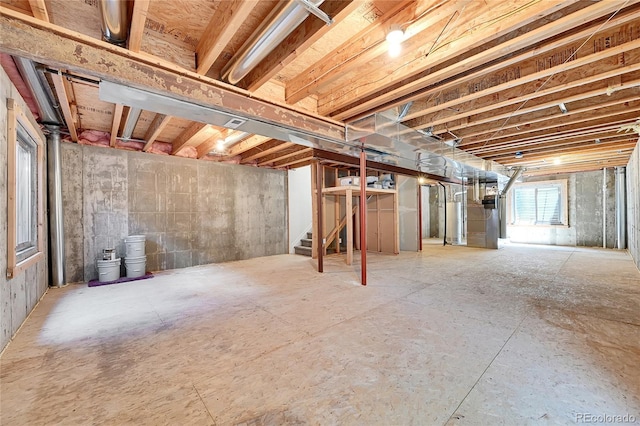 below grade area featuring heating unit and stairs
