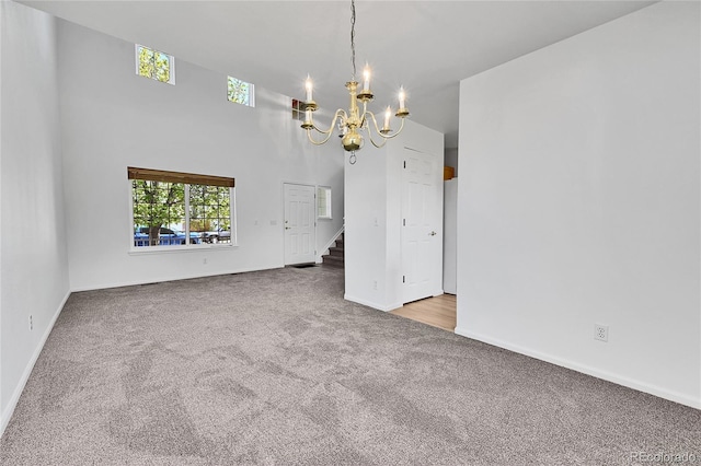 11963 Dahlia Dr, Thornton, CO 80233 - carpeted empty room featuring a chandelier, plenty of natural light, stairway, and baseboards