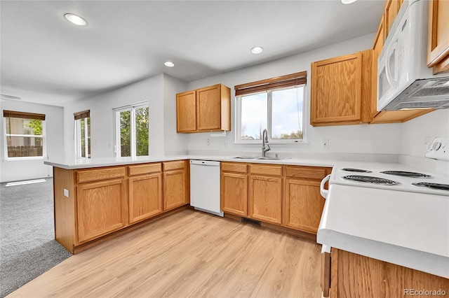 11963 Dahlia Dr, Thornton, CO 80233 - kitchen featuring white appliances, a peninsula, a sink, light countertops, and recessed lighting