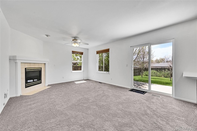 11963 Dahlia Dr, Thornton, CO 80233 - unfurnished living room featuring carpet, ceiling fan, a tile fireplace, and baseboards