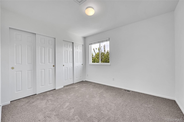 11963 Dahlia Dr, Thornton, CO 80233 - unfurnished bedroom featuring two closets, carpet floors, and baseboards