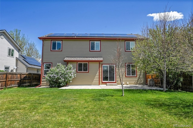 11963 Dahlia Dr, Thornton, CO 80233 - rear view of house with roof mounted solar panels and a patio
