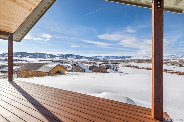 snow covered deck featuring a mountain view