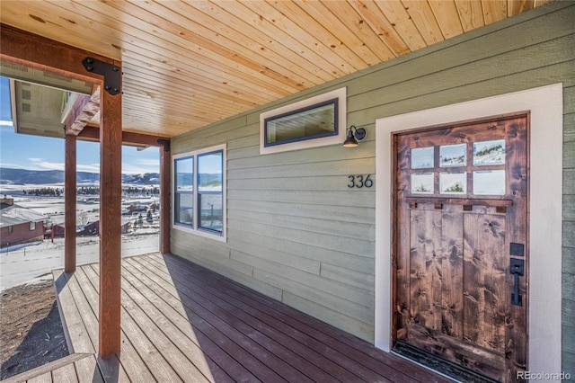 snow covered deck featuring a mountain view