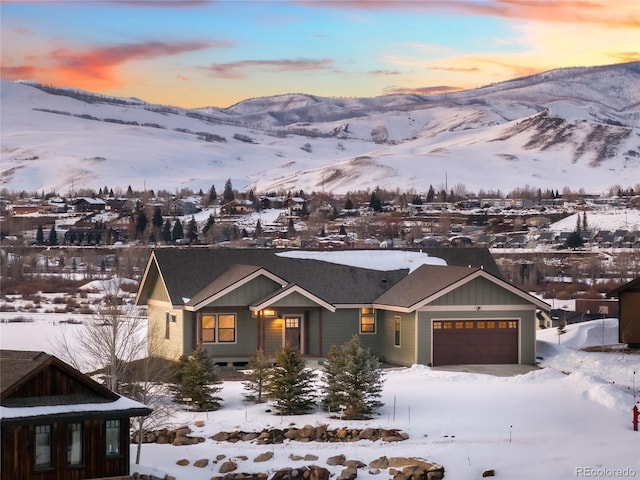 exterior space with an attached garage and a mountain view