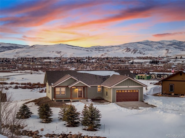 view of front of house with a garage, a mountain view, and board and batten siding