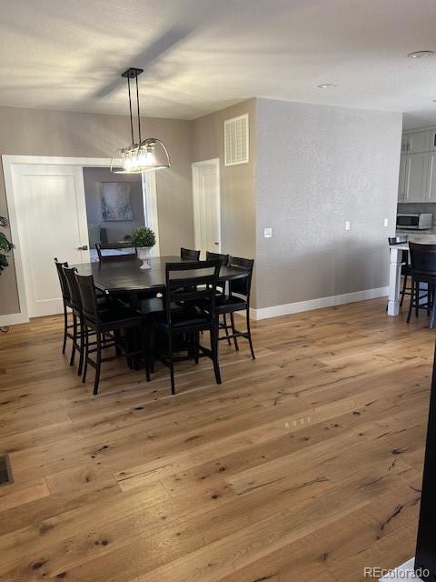 dining room with a chandelier and hardwood / wood-style flooring