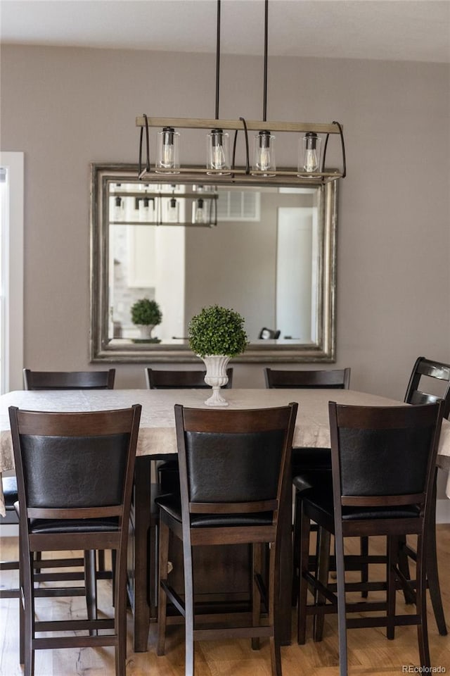 dining room with wood-type flooring