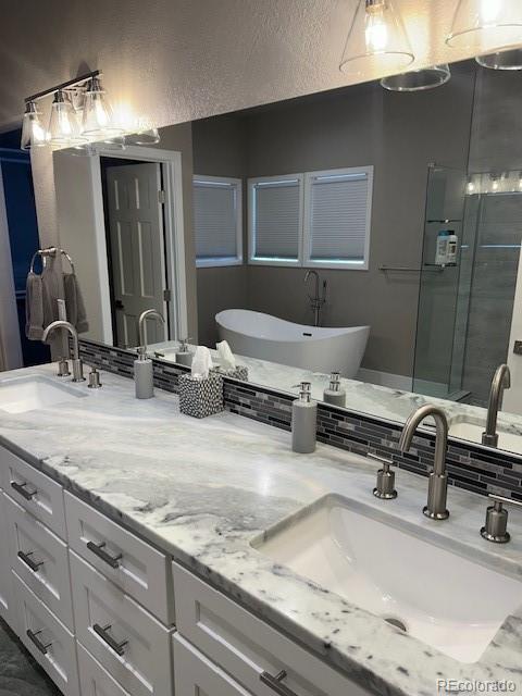 bathroom with vanity, plus walk in shower, and tasteful backsplash