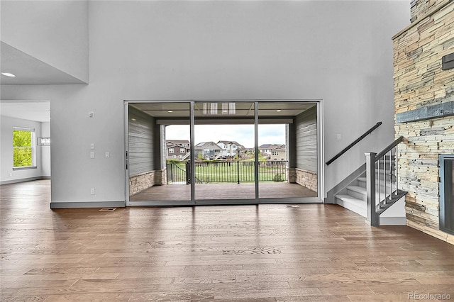 8179 S Kellerman Cir, Aurora, CO 80016 - unfurnished living room featuring a high ceiling, wood finished floors, stairway, and baseboards