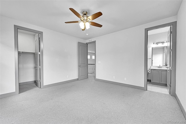 8179 S Kellerman Cir, Aurora, CO 80016 - unfurnished bedroom with baseboards, a sink, a walk in closet, ceiling fan, and a closet