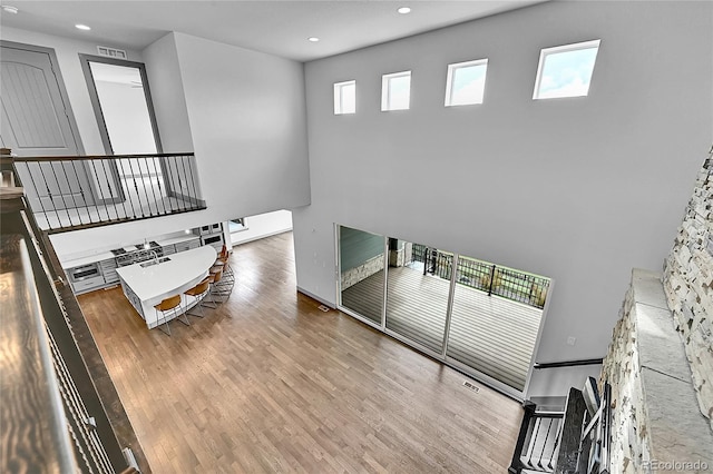 8179 S Kellerman Cir, Aurora, CO 80016 - stairway featuring recessed lighting, wood finished floors, and a high ceiling
