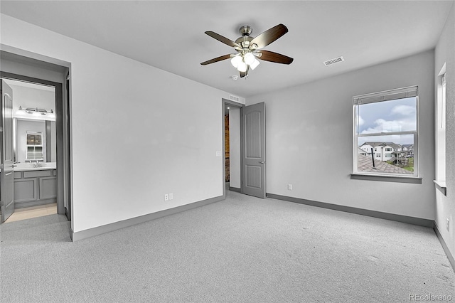 8179 S Kellerman Cir, Aurora, CO 80016 - unfurnished bedroom featuring carpet flooring, baseboards, connected bathroom, and a ceiling fan