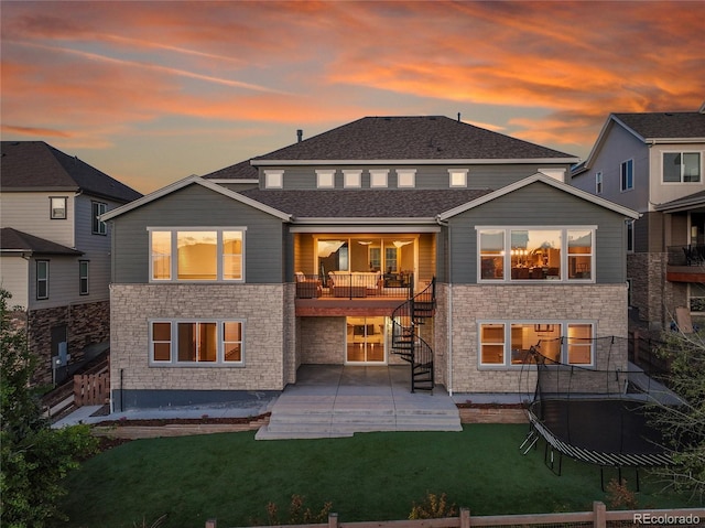 8179 S Kellerman Cir, Aurora, CO 80016 - rear view of property with stairway, a patio area, stone siding, and a yard