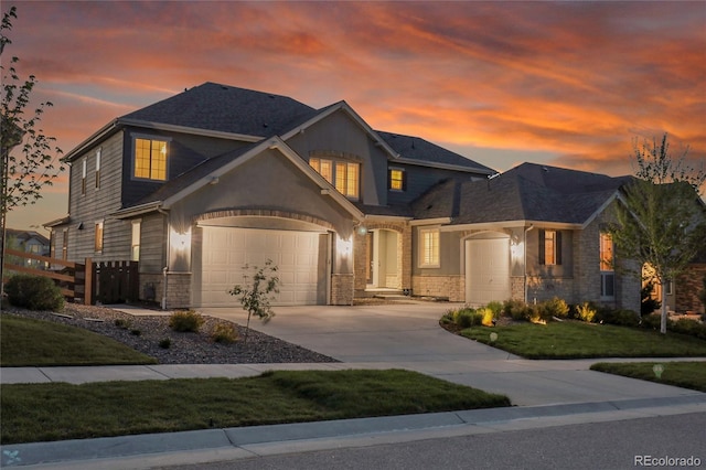 8179 S Kellerman Cir, Aurora, CO 80016 - view of front of house with concrete driveway, stone siding, and an attached garage
