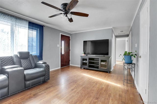 living room with ceiling fan, hardwood / wood-style floors, and ornamental molding