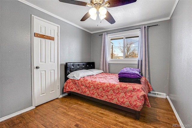 bedroom featuring ceiling fan, hardwood / wood-style floors, and ornamental molding