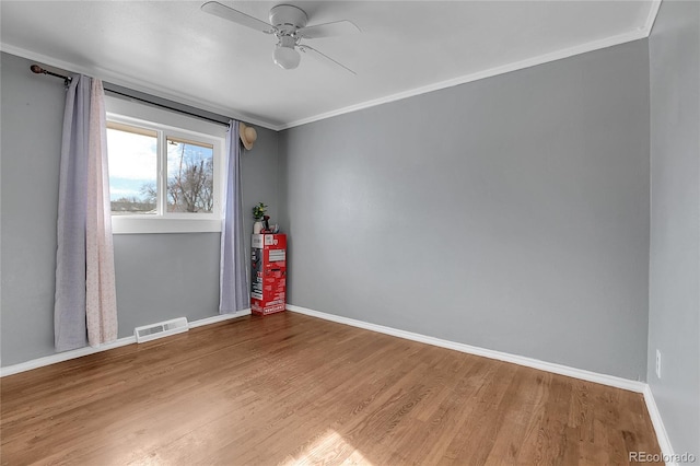 unfurnished room featuring wood-type flooring, ornamental molding, and ceiling fan