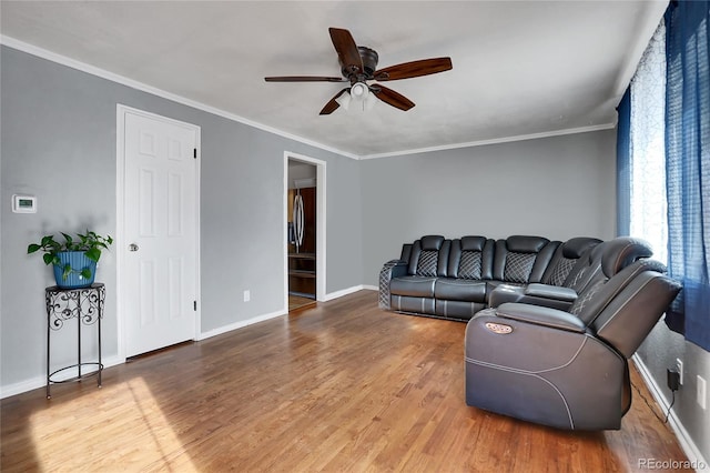 living room featuring ceiling fan, crown molding, and hardwood / wood-style floors