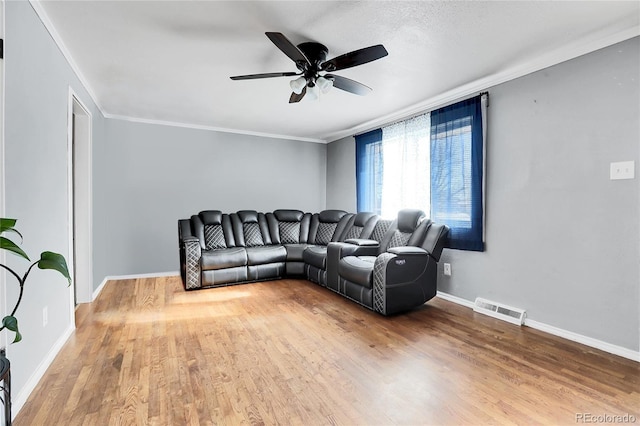 living room with ornamental molding, ceiling fan, a textured ceiling, and hardwood / wood-style flooring