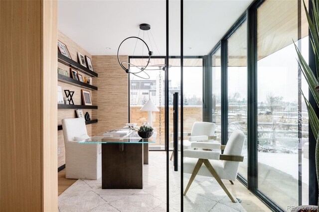 home office with floor to ceiling windows and a chandelier