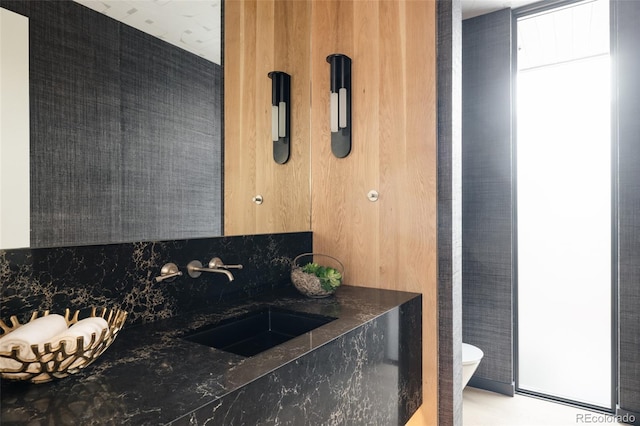 kitchen with sink and dark stone countertops