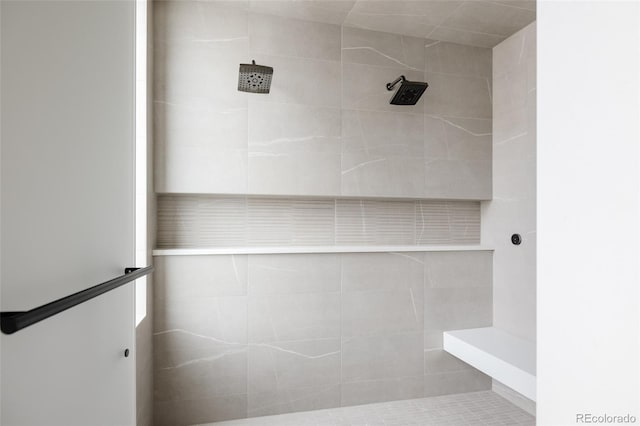 bathroom with a tile shower