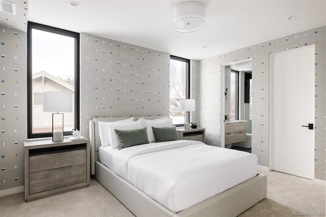 carpeted bedroom featuring floor to ceiling windows and multiple windows