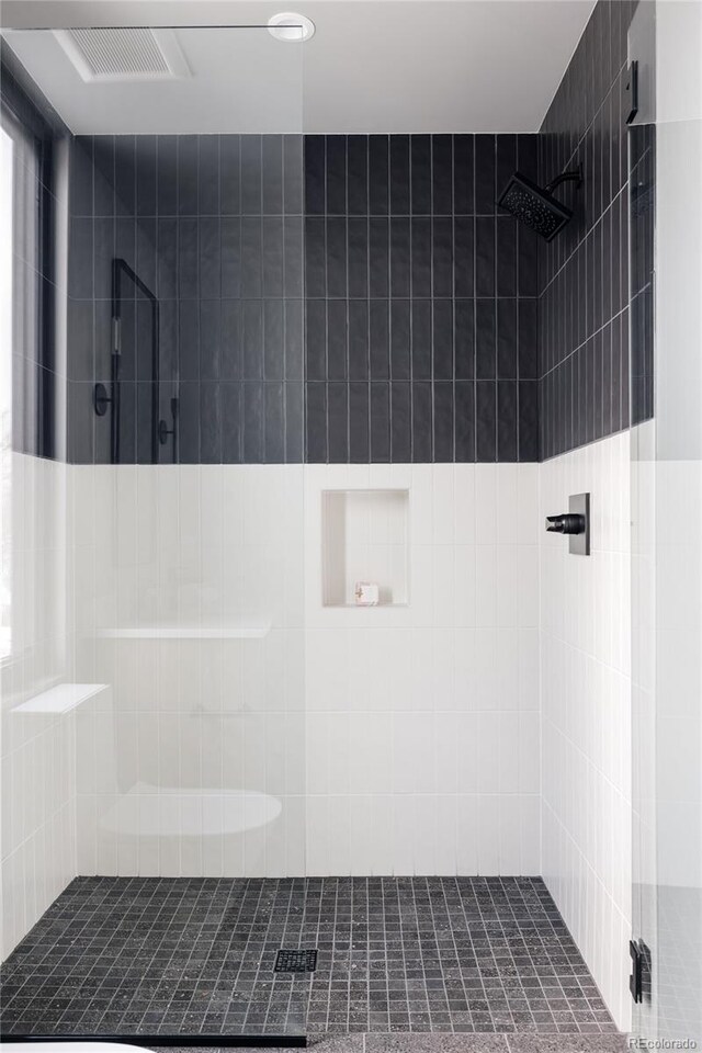 bathroom with a tile shower