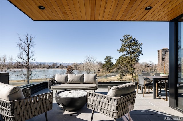 exterior space with a water view and outdoor lounge area