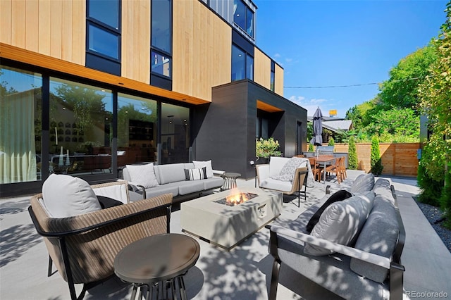 view of patio featuring an outdoor living space with a fire pit