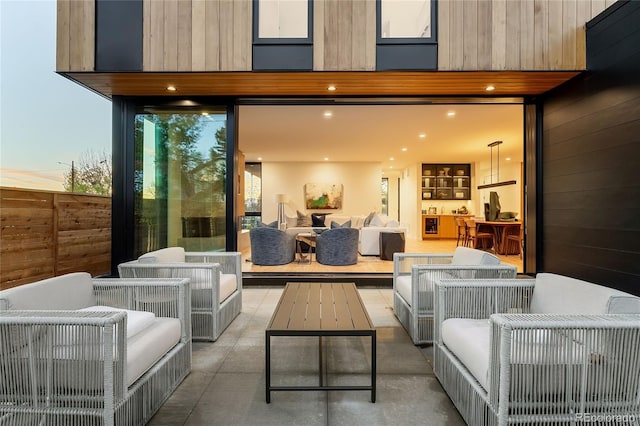 patio terrace at dusk featuring an outdoor hangout area