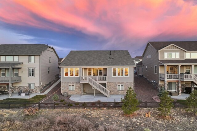 8751 S Wenatchee Ct, Aurora, CO 80016 - back of property at dusk with a patio area, stairway, a fenced backyard, and central air condition unit