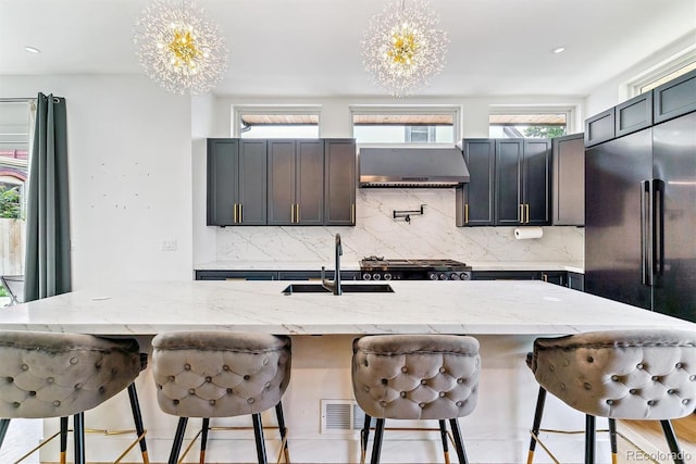 2280 W 42nd Ave, Denver, CO 80211 - kitchen featuring a chandelier, exhaust hood, a sink, tasteful backsplash, and recessed lighting