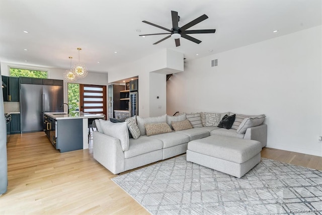 2280 W 42nd Ave, Denver, CO 80211 - living area with light wood-style floors, ceiling fan, a chandelier, and recessed lighting